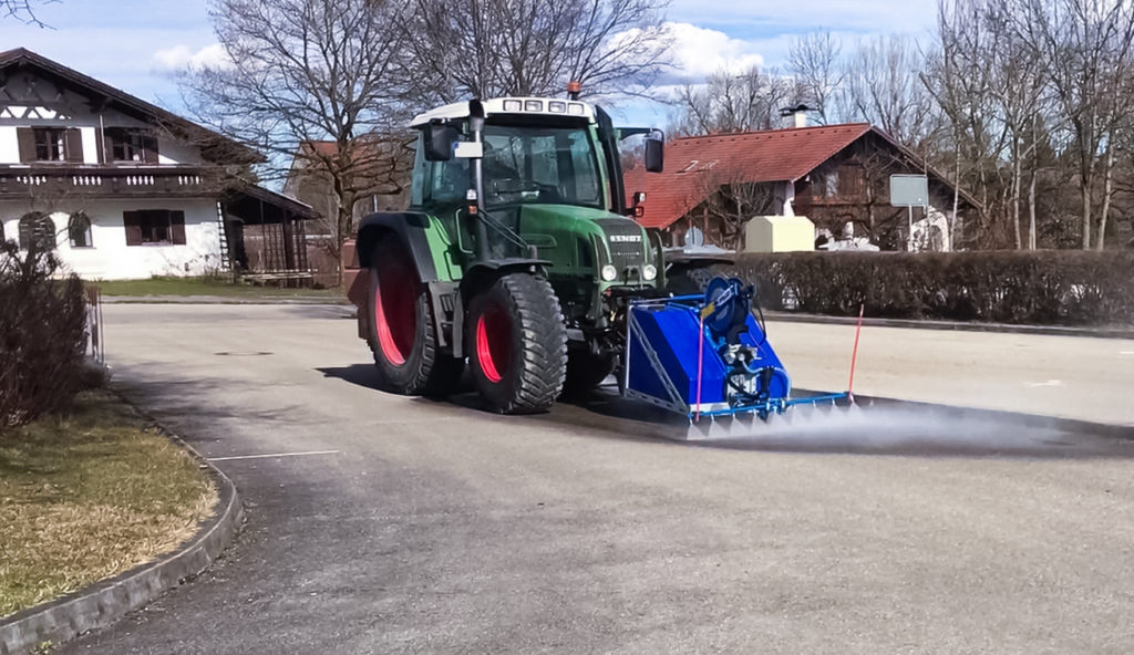 Tractor equipped with DYNASET KPL High Pressure Street Washing Unit.