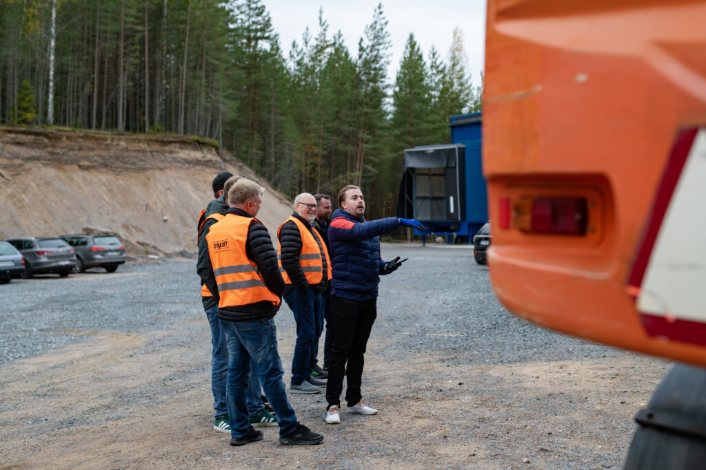 Demonstration in progress near an excavator.