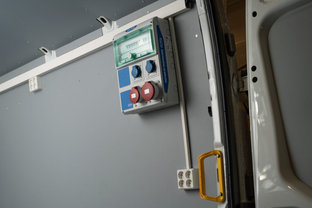 DYNASET Electric Center installed on a vehicle, providing easy access to electrical connections from the generator.